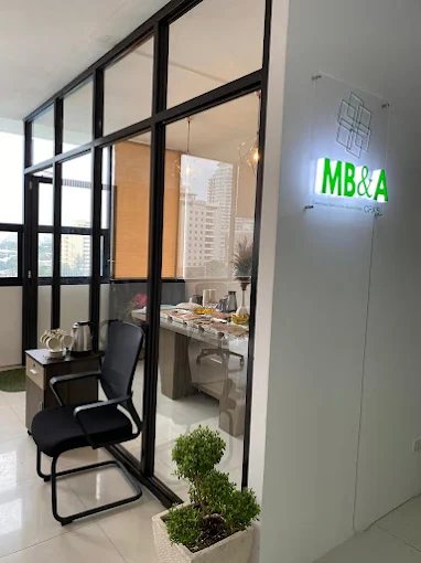 Entrance of the MB&A CPAs office in Cebu with the illuminated MB&A sign